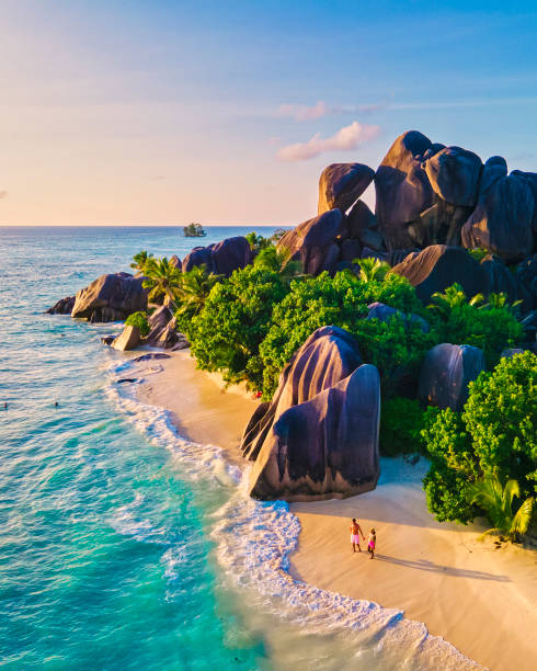 istock Anse Source d'Argent beach, La Digue Island, Seyshelles, Drone aerial view of La Digue Seychelles bird eye view, couple men and woman walking at the beach during sunset at a luxury vacation 1575722801