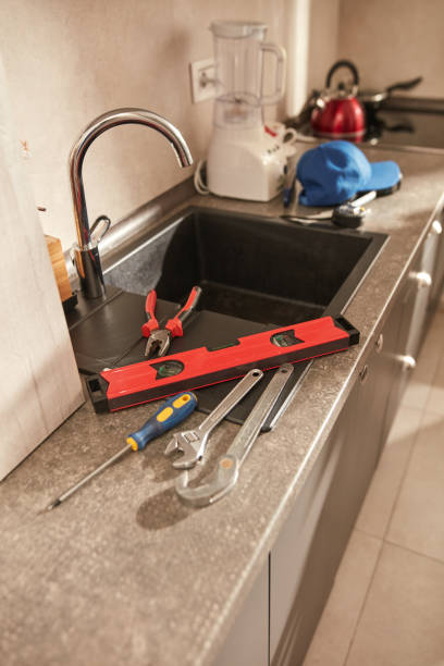 istock Plumber tools for fixing and repairing water tap on the kitchen sink. 1575724936