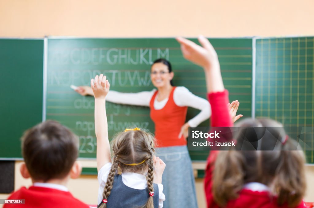 Children Raising Hands In Class, Rear View  Child Stock Photo