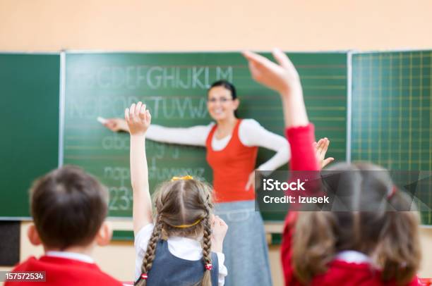 Children Raising Hands In Class Rear View Stock Photo - Download Image Now - Child, Classroom, Smiling