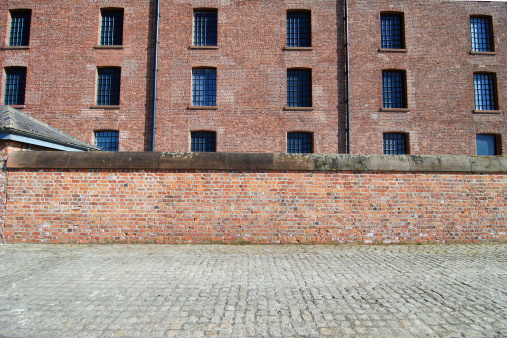 Red brick wall with sidewalk at the Albert Dock, Liverpool