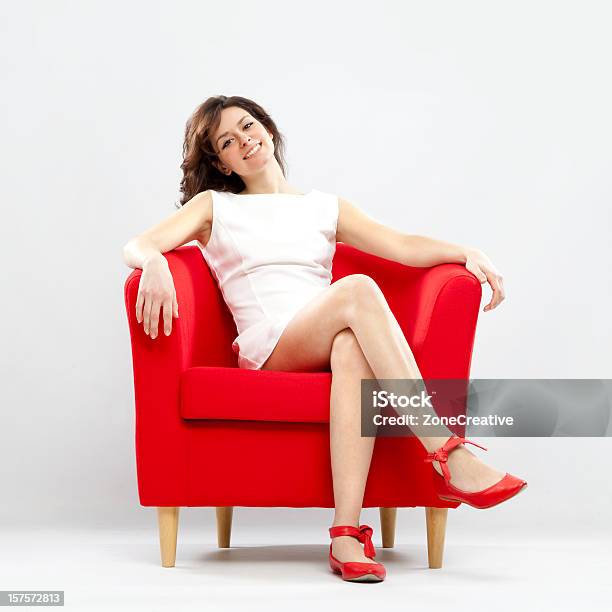 Beautiful Smiling Girl Relaxed On Red Armchair Stock Photo - Download Image Now - Armchair, Women, One Woman Only