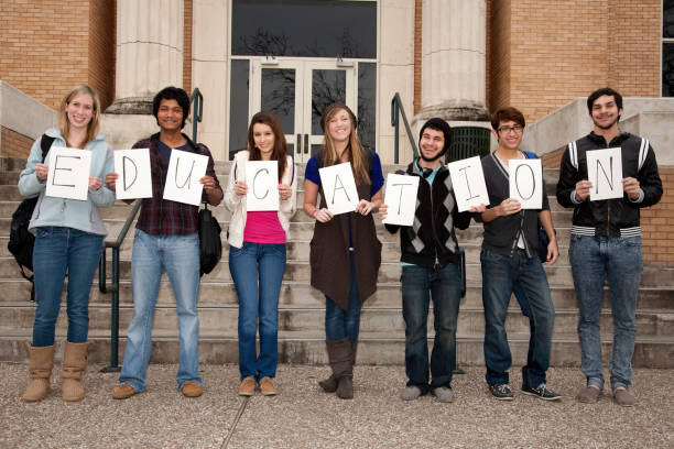 istock Education Sign Held By Happy Group of College Students 157572973