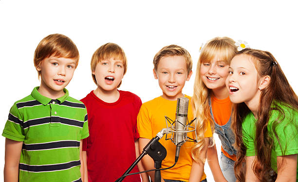Happy boys and girls having fun. Group of energetic primary school children playing together. Bunch of cheerful little Caucasian kids raising hands in air after huddling or high fiving each other