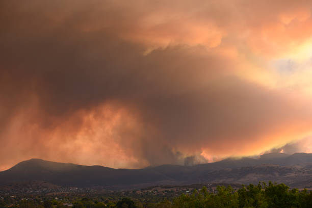 istock Wild fires send heavy smoke clouds over the hills and city 1575733573