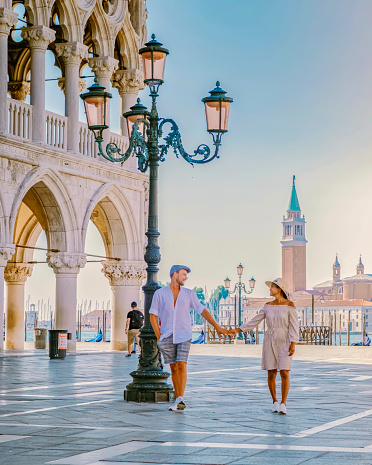 couple on a city trip in Venice, view of piazza San Marco, Doge's Palace Palazzo Ducale in Venice, Asian women and caucasian men on city trip in Venice