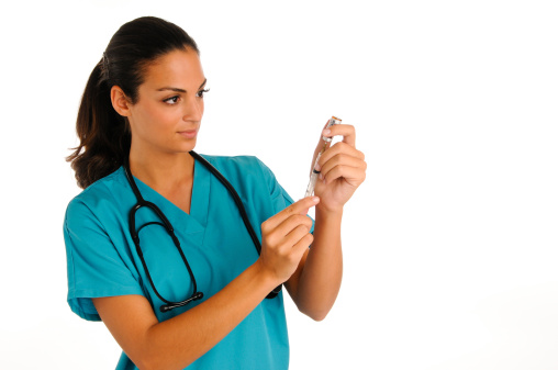 Young nurse prepares to give an injection