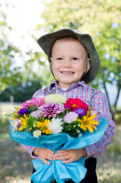 istock Grinning young boy with flowers 157575779