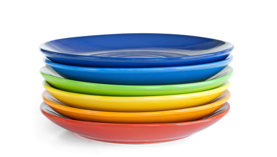 A stack of rainbow dishes on white background.