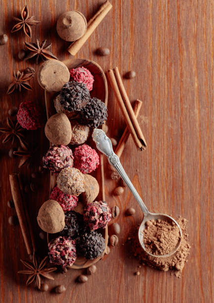 istock Chocolate truffles and spoon with cocoa powder. 1575770082