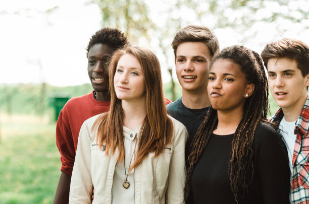 istock multiracial friends embracing together 1575786567