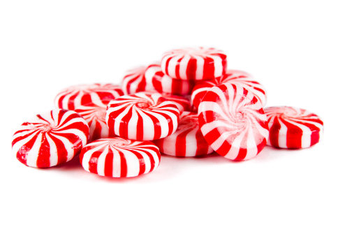 Christmas candy cane on green background. Space for text