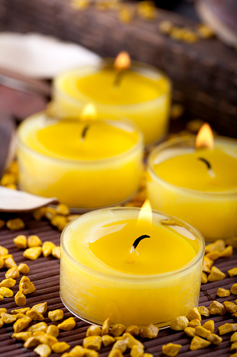 Few small yellow candles and stones arrangement\n\n[url=http://www.istockphoto.com/search/lightbox/7682791/][img]http://img268.imageshack.us/img268/5311/candleslightbox.jpg[/img][/url]