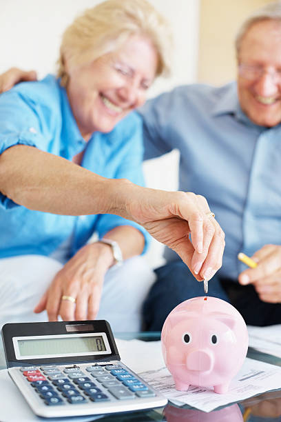 istock Happy senior couple saving money at home 157579192