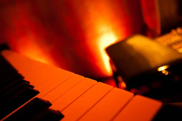 stylish red illuminated piano bar, very selective focus in front on the piano keys