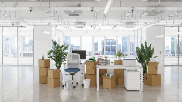 istock Empty Office With Chairs, Cardboard Boxes, Plants, Computers And Other Office Equipments. Moving To New Office Or Bankruptcy Concept 1575792691