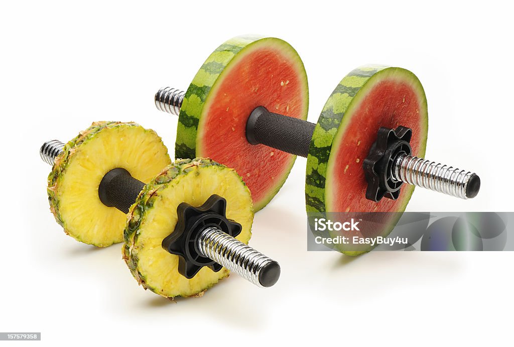 Healthy lifestyle Healthy lifestyle concept with dumbells and pineapple and watermelon as weight, isolated on white. More healthy concept... Exercising Stock Photo