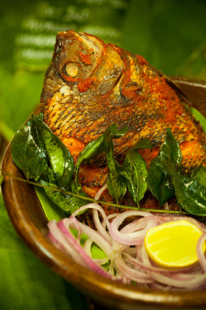 istock Gourmet Indian fried fish with curry leaves, lemon and onion 157579532