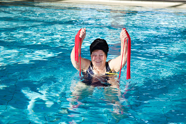 istock senior woman enjoying exercise in pooö 157579536