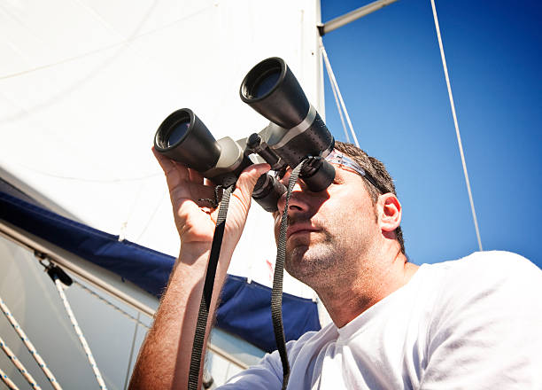 istock Sailor with binoculars on sailboat 157579571