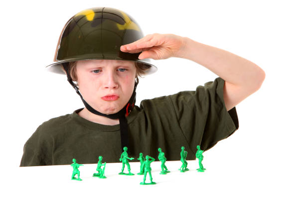 istock boy saluting green army men 157579998