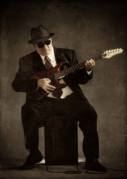 istock elegant senior playing an electric guitar 157580084
