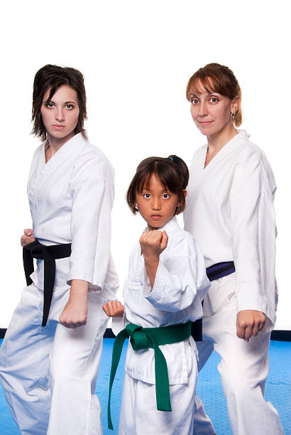 istock Three females in martial arts uniforms 157580126