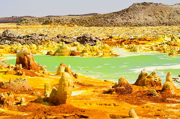 Inside Dallol volcano crater at Danakil Depression Ethiopia The volcanic explosion crater of Dallol in the Danakil Depresseion in Nothern Ethiopia. The Dallol crater was formed during a phreatic eruption in 1926. This crater is known as the lowest subaerial vulcanic vents in the world. The surreal colours are caused by green acid ponds and iron oxides and sulfur. danakil depression stock pictures, royalty-free photos & images