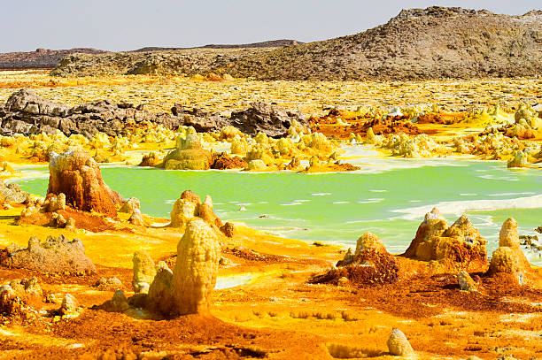 Inside Dallol volcano crater at Danakil Depression Ethiopia The volcanic explosion crater of Dallol in the Danakil Depresseion in Nothern Ethiopia. The Dallol crater was formed during a phreatic eruption in 1926. This crater is known as the lowest subaerial vulcanic vents in the world. The surreal colours are caused by green acid ponds and iron oxides and sulfur. dallol ethiopia stock pictures, royalty-free photos & images