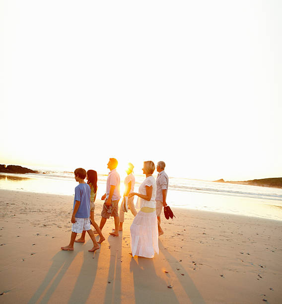 istock Three generations of the same family walking on the beach 157580204