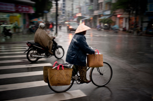Riding A Bicycle In The Rain In Nha Trang, Vietnam