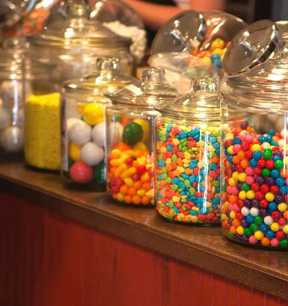 Old fashioned candy store with large jars of candy on the counter.