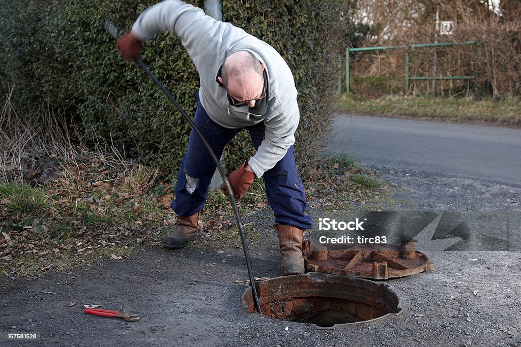Man clearing the drains 50-54 Years Stock Photo
