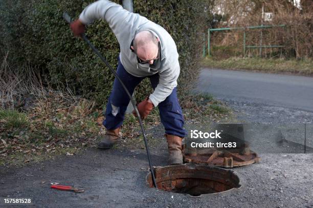 Man Clearing The Drains Stock Photo - Download Image Now - 50-54 Years, Adult, Balding