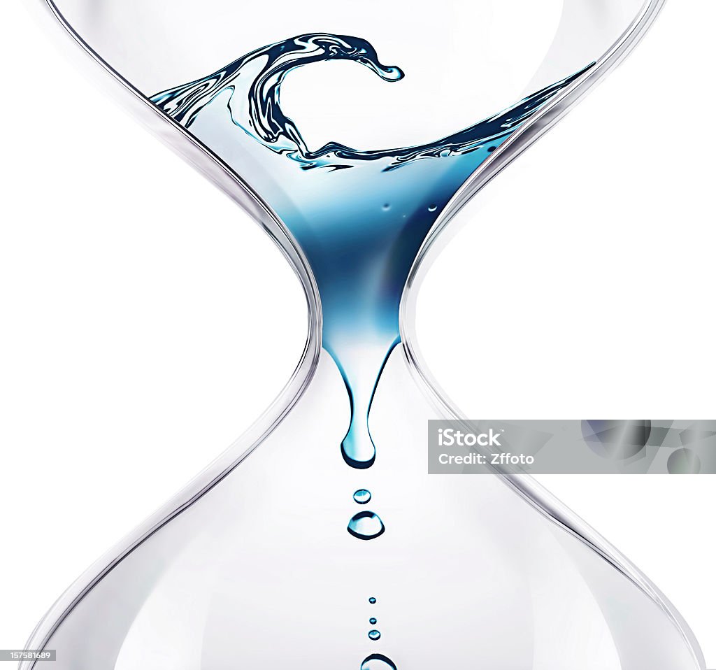 Water dripping through an hourglass hourglass with dripping water close-up Water Stock Photo