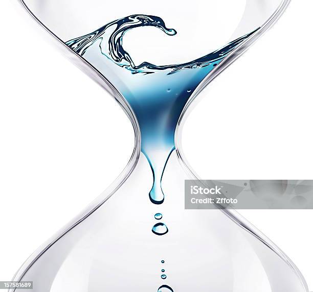 Water Dripping Through An Hourglass Stock Photo - Download Image Now - Water, Hourglass, Clock