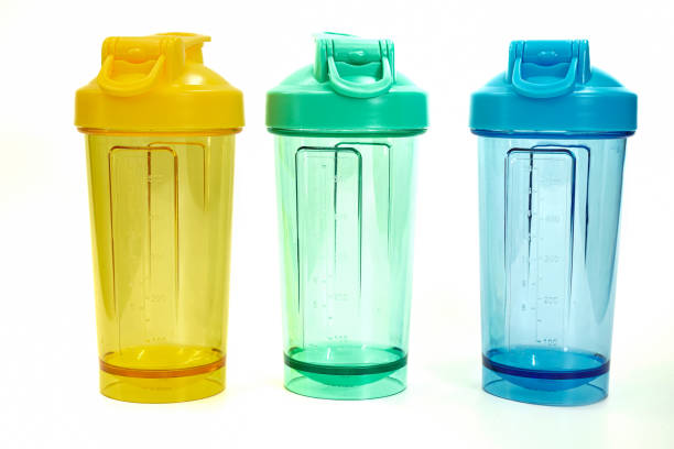 istock Image showing clear blue, green and yellow protein shake bottle containers on a white background. 1575817918