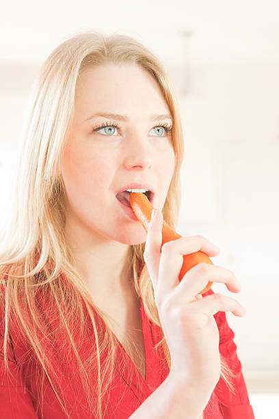 istock Pretty Girl Eating A Carrot 157581920