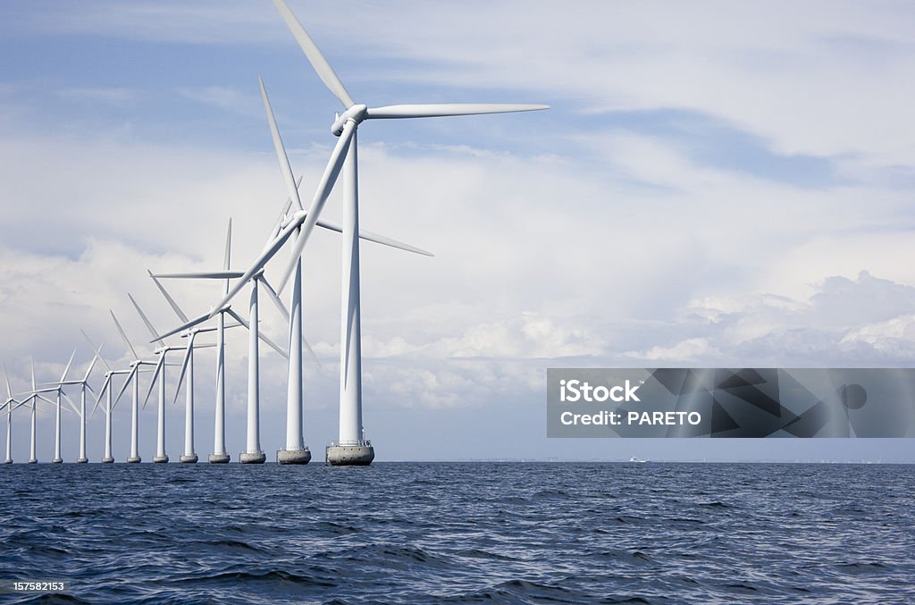 Long row a very tall windmills offshore Off shore windmills at Middelgrunden just outside Copenhagen, Denmark Wind Turbine Stock Photo