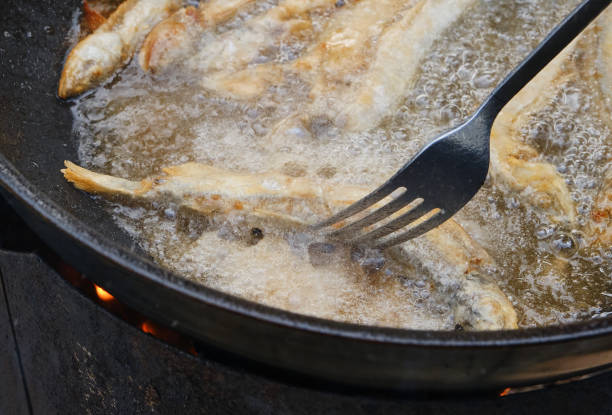 istock Small crispy fish are fried in oil. 1575822585