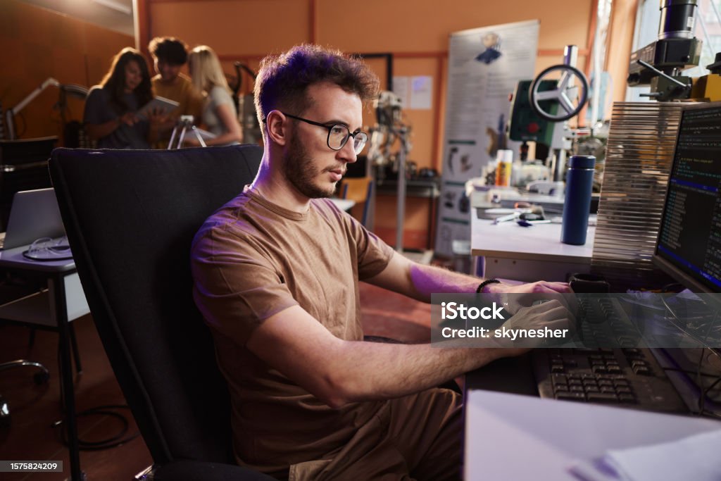Male Programmer Coding A Computer Language On Pc In Robotics Lab Stock ...