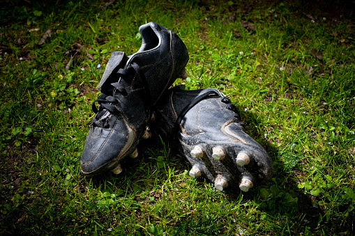 dirty rugby shoes on a grassy field