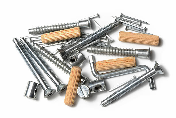 Set of screws, pins and wooden dowels for furniture assembly Furniture assembly kit, swedish style, with screws, bolts, nails, wooden dowel and allen key tool. Isolated on white. bolt fastener photos stock pictures, royalty-free photos & images