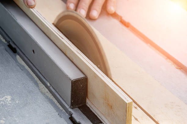 istock turner works on a lathe. Close-up. saw table. a man saws a tree with a milling machine. An experienced carpenter cuts a wooden board with a circular saw. Production of wood materials. Real life 1575827330