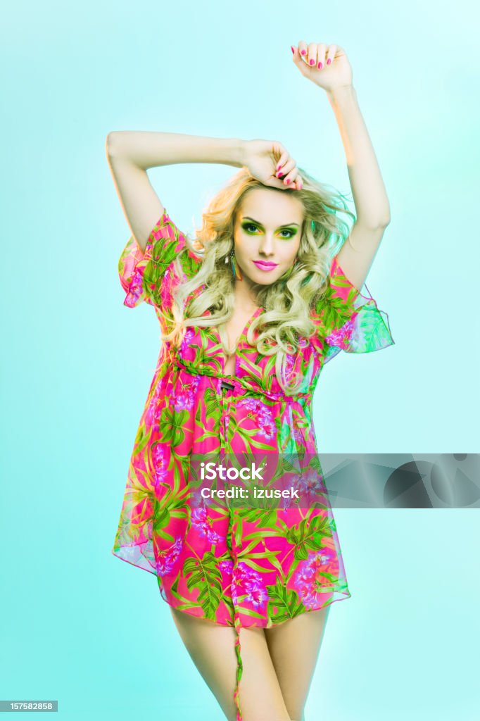 Beautiful blonde woman posing in colorful tunic.  20-24 Years Stock Photo