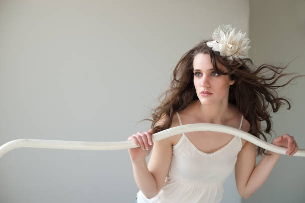 Fashion image of young woman with dramatic hair accessory stock photo