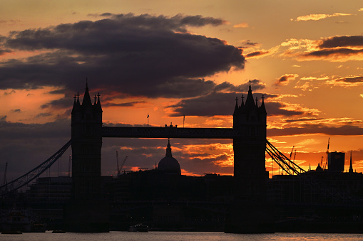 Dramatic sunset over Tower Bridge and the dome of St Paul's Cathedral in London