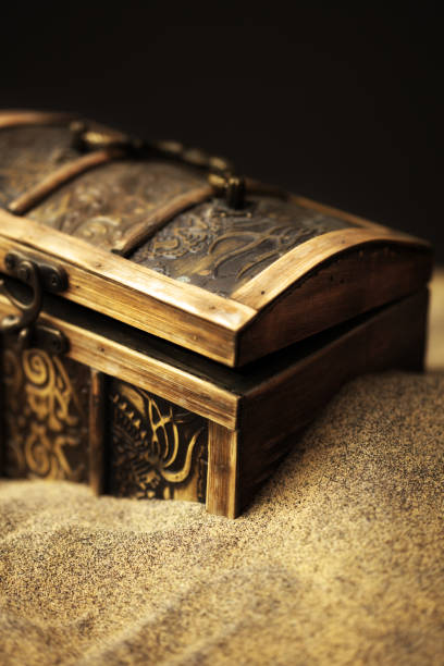 close up locked chest in the sand on the beach