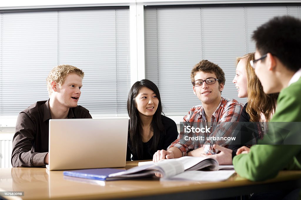 Study group Five students studying in a lecture room Adult Stock Photo