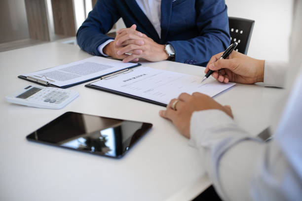 istock Sales manager giving advice application form document, considering mortgage loan offer for car and house insurance. Real estate investment Property insurance and security. Real estate agent offer house. 1575832717